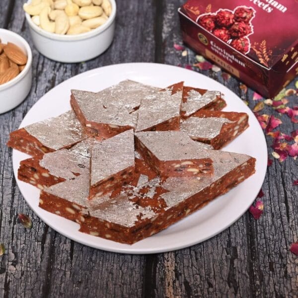 Smooth fig-based Anjeer Katli squares with elegant nutty garnish