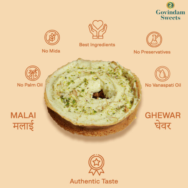 Close-up of Malai Ghewar topped with thick rabri and chopped dry fruits